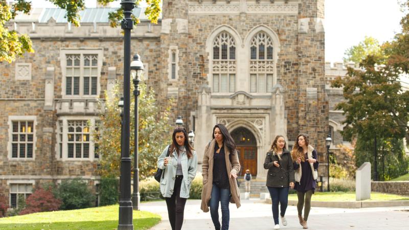 A group of women walk in front of Linderman Library